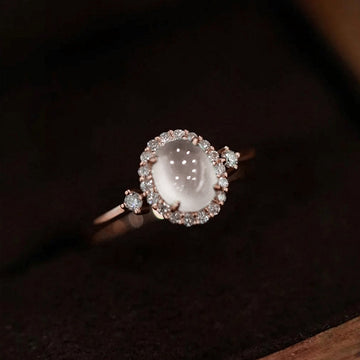 Pale Pink Oval Cabochon Halo Ring In Polished Rose Tone