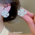Pearl Center Radiating Flower Clip On Earrings With Polished Metal Details view 4