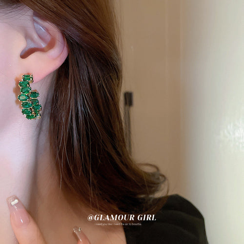 Green Crystal Open Hoop Earrings Polished Metal Jewelry modeled at the ear