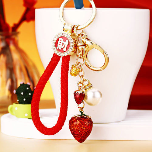 A second supplied view shows another pictured color or design of the mixed fortune motif keychain.