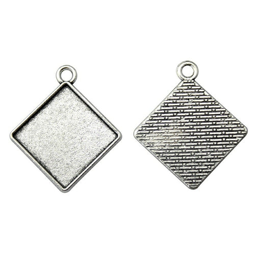 Styled view of diamond-oriented square bezel trays in two antique finishes