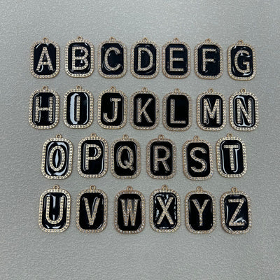 Full alphabet set from A to Z shown as black enamel rhinestone letter charms on a gray background