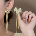 Gold Tone Sculptural Bow and Four Bar Tassel Earrings view 1