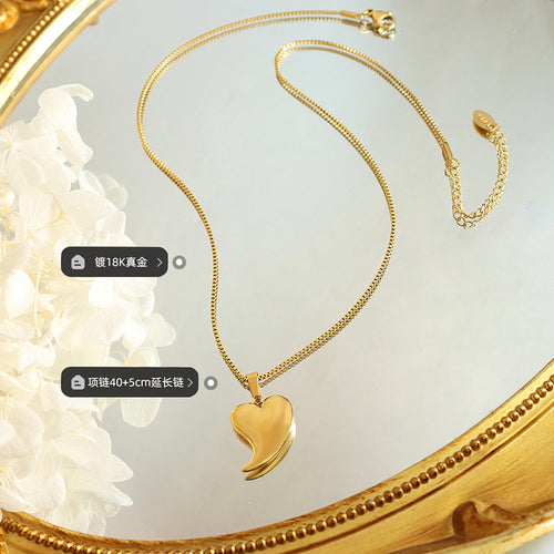 Gold heart necklace flat lay in gold frame with plating length labels