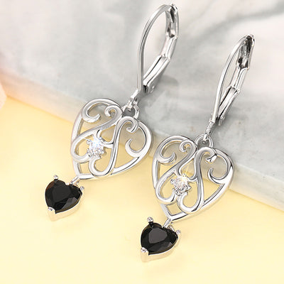 Silver hollow heart black drop leverback earrings product shot on marble