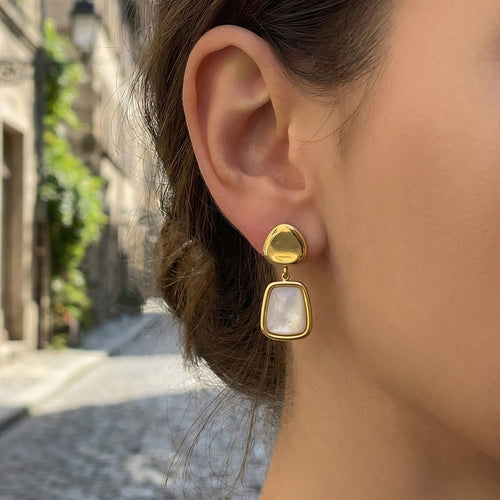 On-ear view of white shell geometric drop earrings in main image 2.