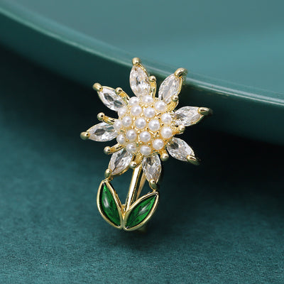 Front view of the white crystal sunflower brooch with green enamel leaves brooch and its color options