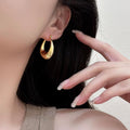 Rounded Teardrop Huggie Earrings In Two Metal Tones view 3