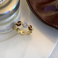 Gold Tone Burgundy And Pale Blue Interlocking Ring With Crystals view 6