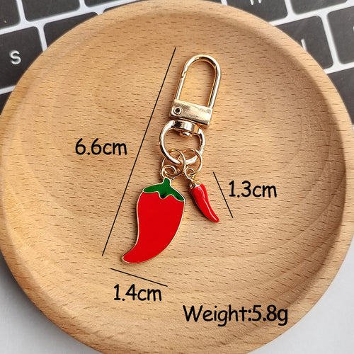 Red chili dual charm keychain with size labels 6.6cm 1.4cm 1.3cm weight 5.8g
