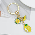 Gold-Tone Enamel Lemon Keychain With Citrus Slice Flower And Butterfly Charms view 2