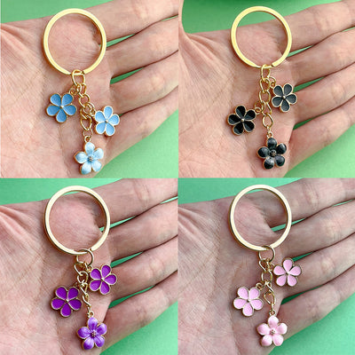 Image 1 showing four different colored flowers on a gold ring.