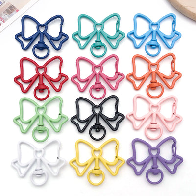 Colorful bow and butterfly jewelry findings arranged on a light background