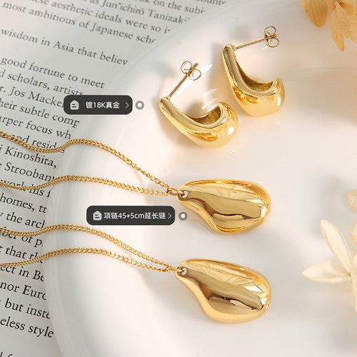 Gold teardrop pendants and studs flat lay with plating length labels
