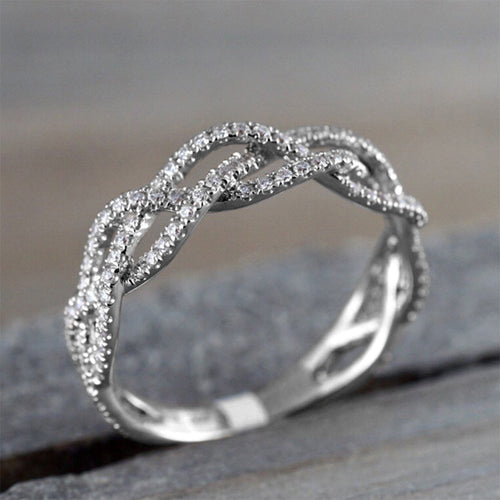 Angled close-up of multi-strand twisted pave infinity ring