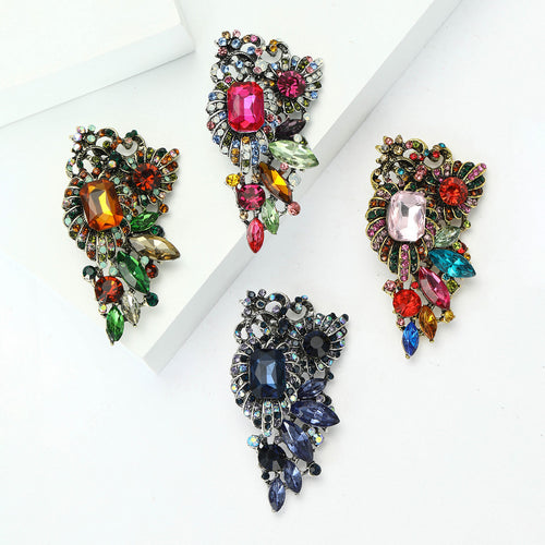 Crystal Grape Cluster brooch In Four Multicolor Designs shown in styled product arrangement