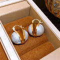 Large White Pearl Gold Tone Huggie Earrings With Metal Details view 6