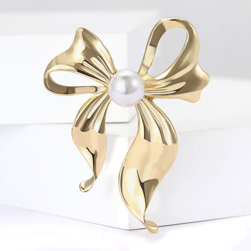 Gold bow brooch close-up product view