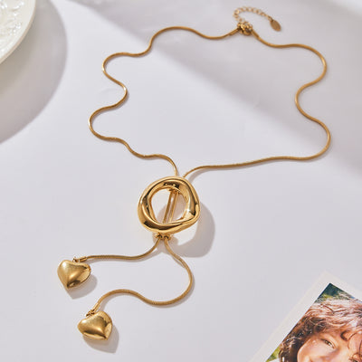 Gold snake chain necklace with irregular ring slider and dual hearts