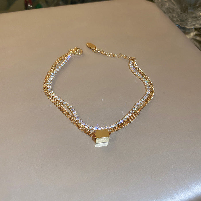 Gold Tone Double Chain Bracelet With Square Padlock Style Charm
