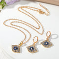 Gold Tone Crystal Evil Eye Necklace and Huggie Earring Options view 2