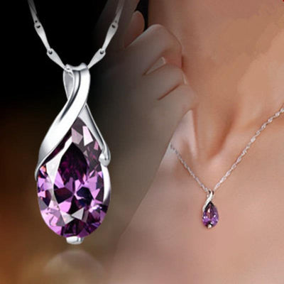 Purple teardrop crystal pendant close-up with necklace worn on collarbone