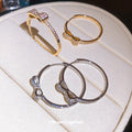 Small Crystal Bow Hoop Earrings in Gold and Silver Tone view 1
