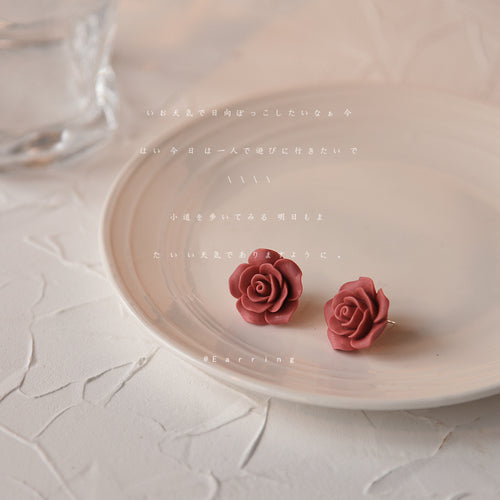 Burgundy-red sculpted-rose flower studs in the first product display.