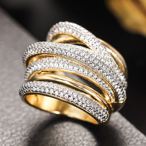 Close-up of crossed gold and silver pave band ring