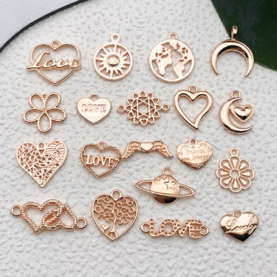 Matte gold-tone seashell charms arranged on a light background