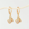 Gold Tone Huggie Earrings with Six Small Symbolic Drop Charms view 8