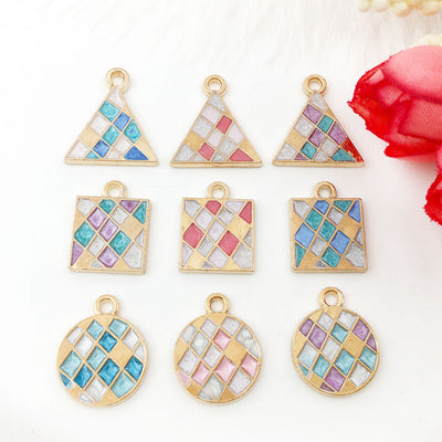 Colorful assorted shape charms arranged on a light background