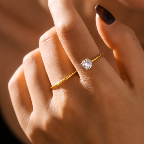 Styled hand view of clear zircon S curve open rings in main image 1.
