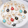 Gold Tone Filigree Oval Teardrop and Star Evil Eye Clip Keychains view 1