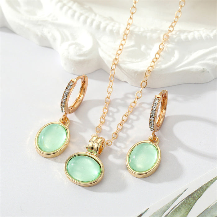 Gold Tone Pale Green Oval Stone Necklace and Huggie Earrings