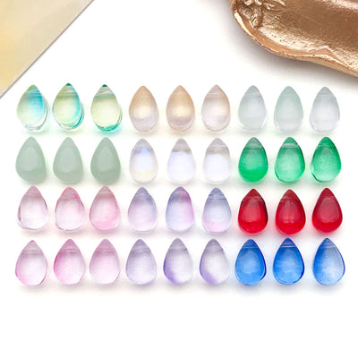 Front product photo of small translucent teardrop glass bead showing the pictured design arrangement