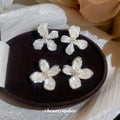 White Floral Shell Look Stud Earrings in Two Sizes view 3