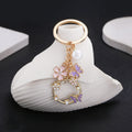 Pink Purple Openwork Butterfly Flower and Pearl Charm Keychain view 1