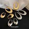 Textured and Polished Oval Hoop Earrings in Gold and Silver view 3