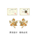 Gold Maple Leaf Stud Earrings With Amber And Clear CZ view 3