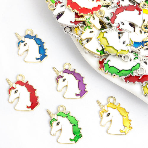 Assorted unicorn charms arranged on a white surface