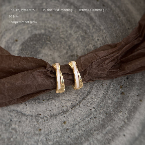 Gold-tone double-line round huggie hoops in the first product display.