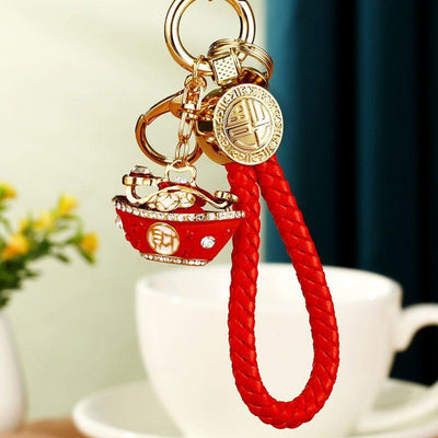 A front product view shows the mixed fortune strap keychain with its visible ornament and key hardware.