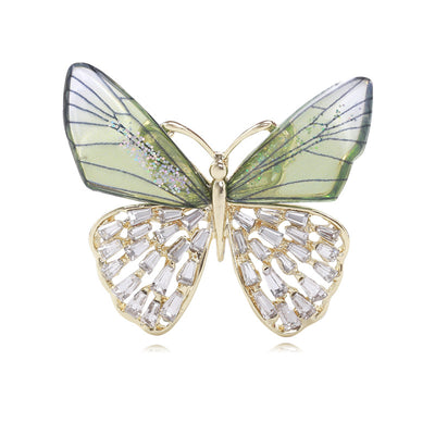 Front view of the gradient wing butterfly brooch in three colors with polished metal detail on a white background