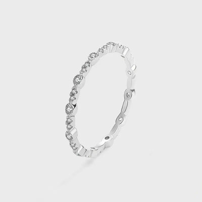 White metal thin bezel stone band ring on gray studio background