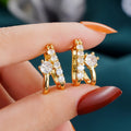 Gold Tone Crossed Bar Crystal Hoop Earrings with Polished Metal Finish view 2
