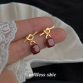 Gold Tone Knot Stud Earrings Burgundy Enamel Drops view 3