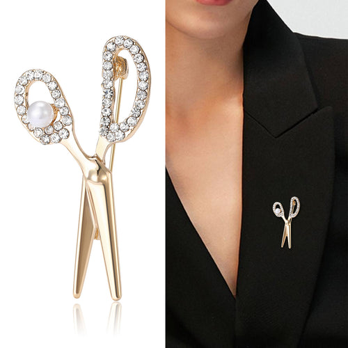 Angled view showing the polished scissors brooch surface