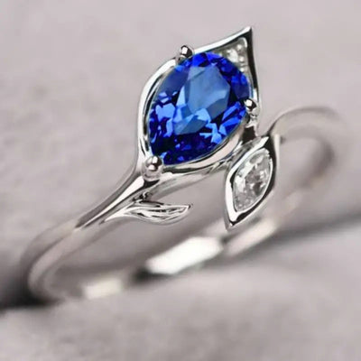 White metal blue pear leaf motif ring close product shot