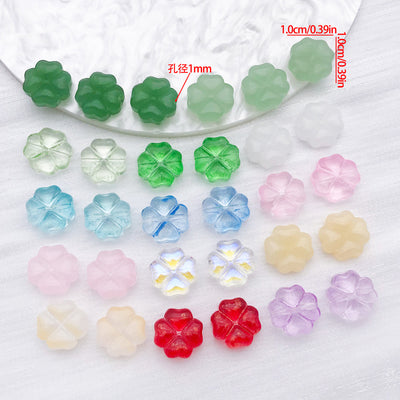 Four leaf clover glass beads in fourteen colors arranged as a full product overview